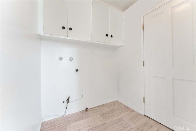 1315 E Wingate St, Covina, CA 91724 - washroom with hookup for a gas dryer, cabinet space, and light wood-style flooring