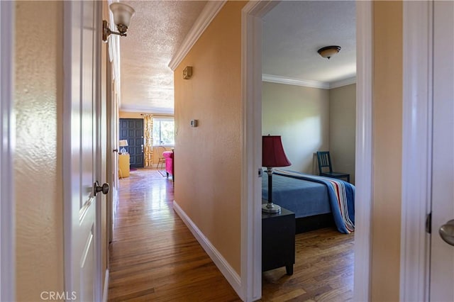 3158 Erie Ave, Merced, CA 95340 - corridor featuring wood finished floors, crown molding, a textured ceiling, and a textured wall