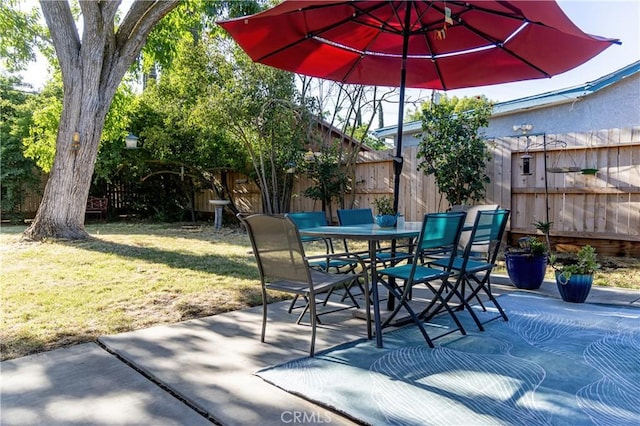 3158 Erie Ave, Merced, CA 95340 - fenced backyard featuring a patio and outdoor dining space