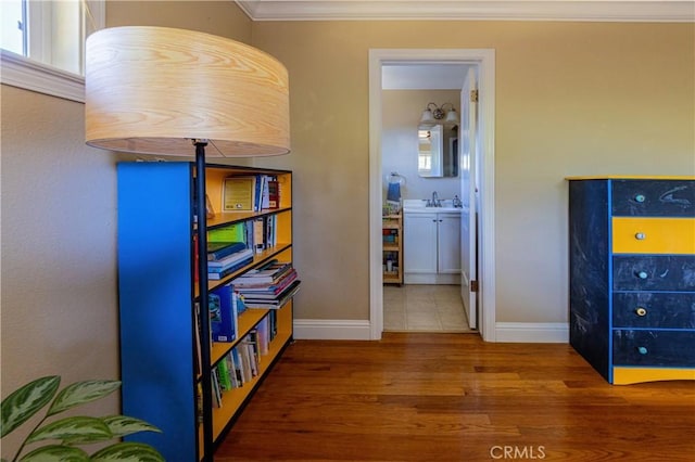 3158 Erie Ave, Merced, CA 95340 - hallway with wood finished floors, ornamental molding, baseboards, and a sink