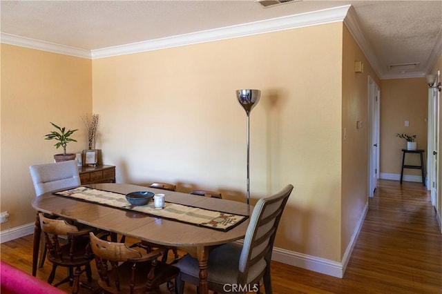 3158 Erie Ave, Merced, CA 95340 - dining room featuring ornamental molding, wood finished floors, and a textured ceiling