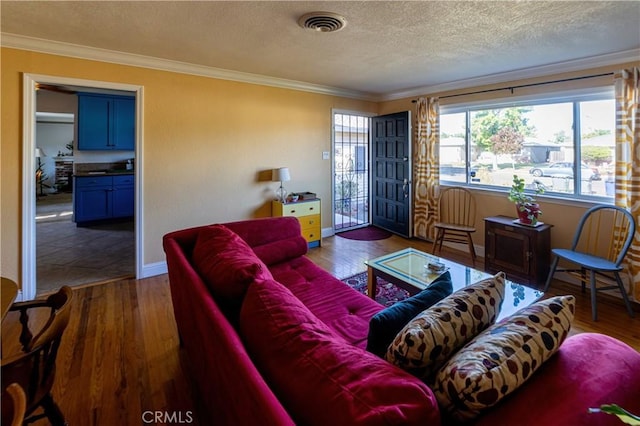 3158 Erie Ave, Merced, CA 95340 - living area with a textured ceiling, crown molding, wood finished floors, and baseboards
