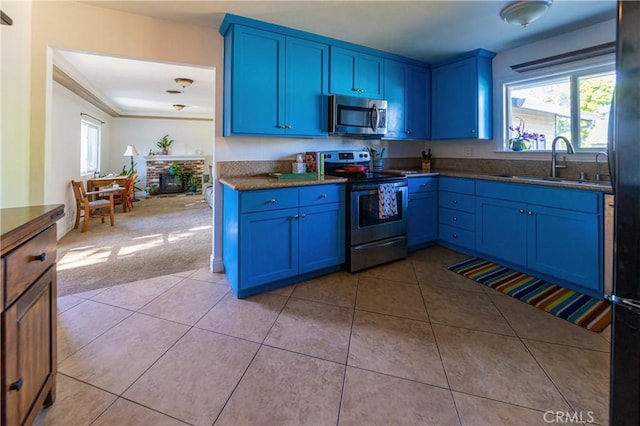3158 Erie Ave, Merced, CA 95340 - kitchen featuring appliances with stainless steel finishes, blue cabinets, and light tile patterned floors