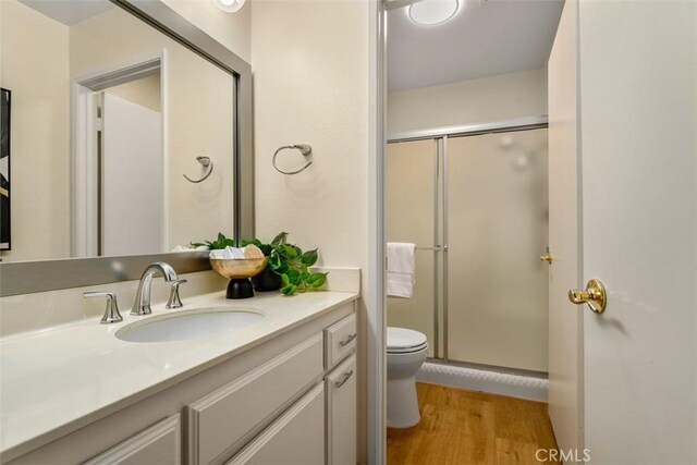 922 N Redding Way Unit E, Upland, CA 91786 - bathroom with toilet, vanity, a shower stall, and wood finished floors