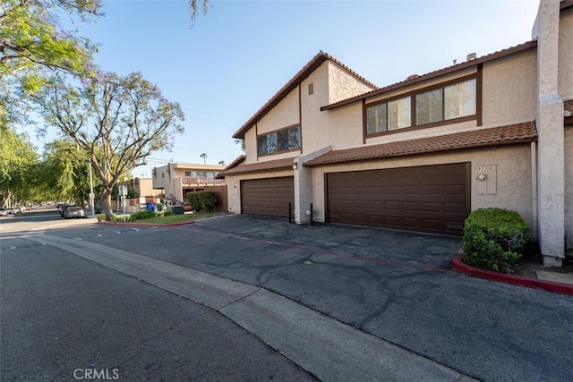 922 N Redding Way Unit E, Upland, CA 91786 - townhome / multi-family property featuring an attached garage, stucco siding, and a tile roof