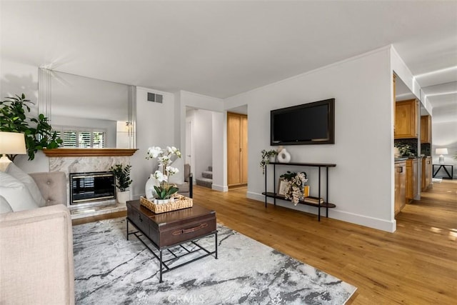 922 N Redding Way Unit E, Upland, CA 91786 - living room featuring light wood-type flooring, a premium fireplace, and baseboards