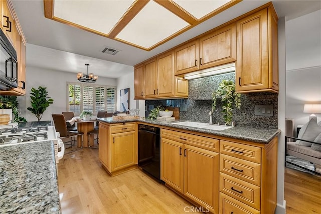 922 N Redding Way Unit E, Upland, CA 91786 - kitchen featuring dishwasher, light wood-style flooring, a chandelier, and decorative backsplash