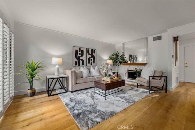 922 N Redding Way Unit E, Upland, CA 91786 - living area featuring a fireplace, wood finished floors, and baseboards