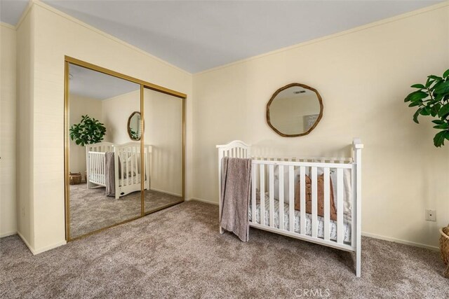 922 N Redding Way Unit E, Upland, CA 91786 - carpeted bedroom with a closet, baseboards, ornamental molding, and a crib