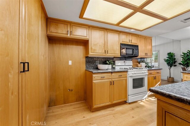 922 N Redding Way Unit E, Upland, CA 91786 - kitchen with gas range gas stove, black microwave, tasteful backsplash, and dark countertops