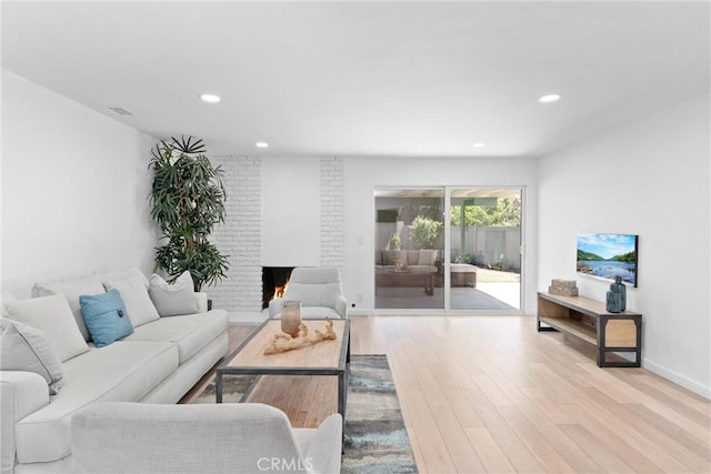 5332 Huntley Ave, Garden Grove, CA 92845 - living room with wood finished floors, recessed lighting, and a brick fireplace