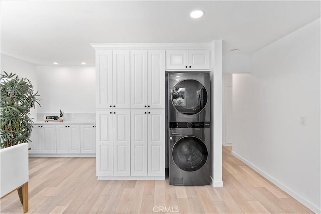 5332 Huntley Ave, Garden Grove, CA 92845 - washroom with stacked washer / drying machine, light wood finished floors, and recessed lighting