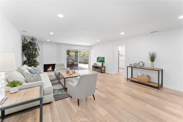 5332 Huntley Ave, Garden Grove, CA 92845 - living area with light wood-style flooring, a fireplace, and recessed lighting