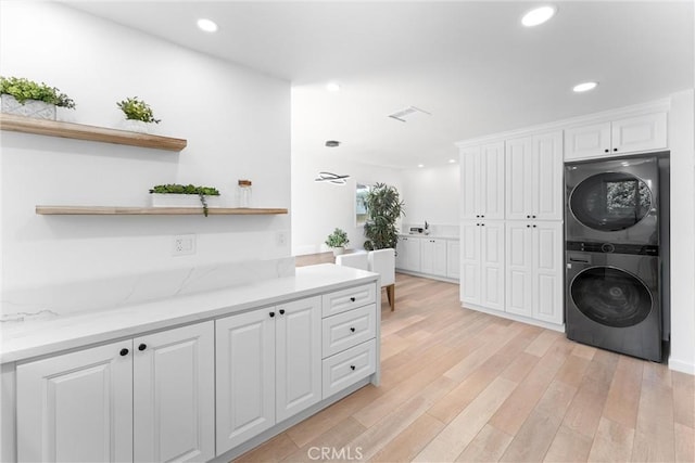 5332 Huntley Ave, Garden Grove, CA 92845 - washroom featuring stacked washing machine and dryer, light wood-style flooring, and recessed lighting