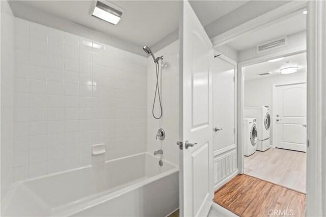 76 City Stroll, Irvine, CA 92620 - full bathroom with washing machine and dryer, wood finished floors, and  shower combination