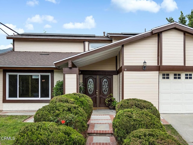 277 Aspen Dr, Monrovia, CA 91016 - view of front of home with roof mounted solar panels and a shingled roof