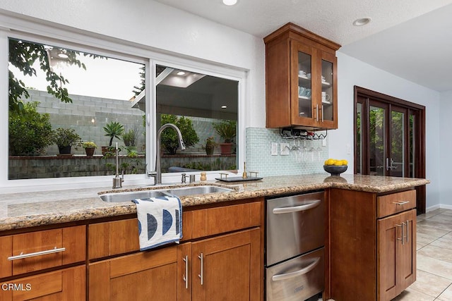 277 Aspen Dr, Monrovia, CA 91016 - kitchen featuring a sink, light stone countertops, light tile patterned floors, brown cabinets, and glass insert cabinets