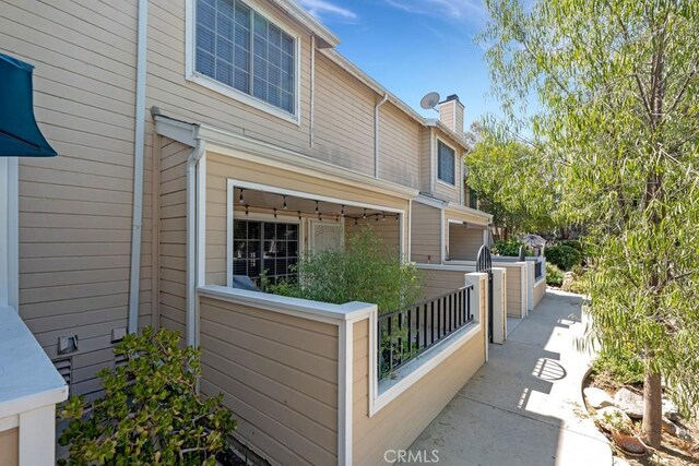 7038 De Celis Pl Unit 9, Van Nuys, CA 91406 - view of home's exterior with a chimney