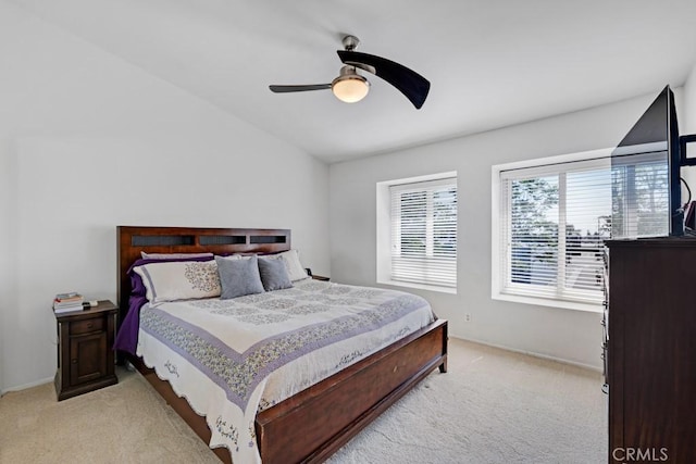 7038 De Celis Pl Unit 9, Van Nuys, CA 91406 - bedroom with light colored carpet, vaulted ceiling, a ceiling fan, and baseboards