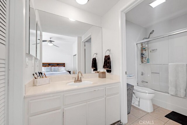 7038 De Celis Pl Unit 9, Van Nuys, CA 91406 - ensuite bathroom featuring tile patterned floors, toilet, vanity, enclosed tub / shower combo, and a ceiling fan
