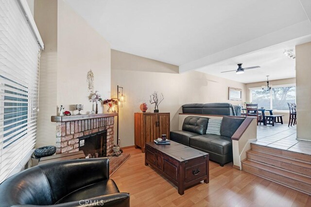 7038 De Celis Pl Unit 9, Van Nuys, CA 91406 - living area featuring light wood-type flooring, a fireplace, and ceiling fan