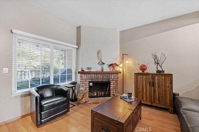7038 De Celis Pl Unit 9, Van Nuys, CA 91406 - living area featuring light wood-style flooring, plenty of natural light, a fireplace, and baseboards