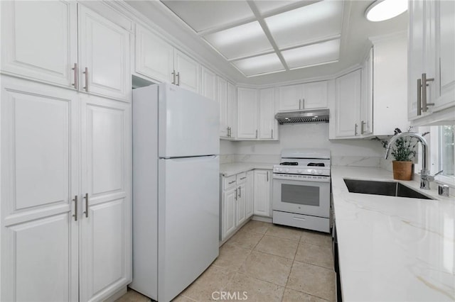 12105 Ramona Blvd, El Monte, CA 91732 - kitchen featuring white appliances, under cabinet range hood, a sink, and white cabinetry