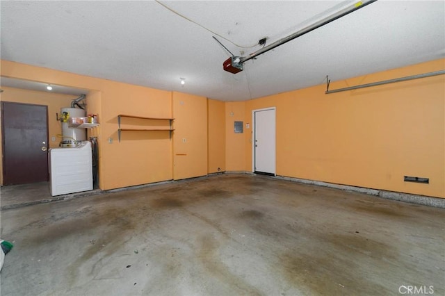 12105 Ramona Blvd, El Monte, CA 91732 - garage featuring a central vacuum unit, a garage door opener, and water heater