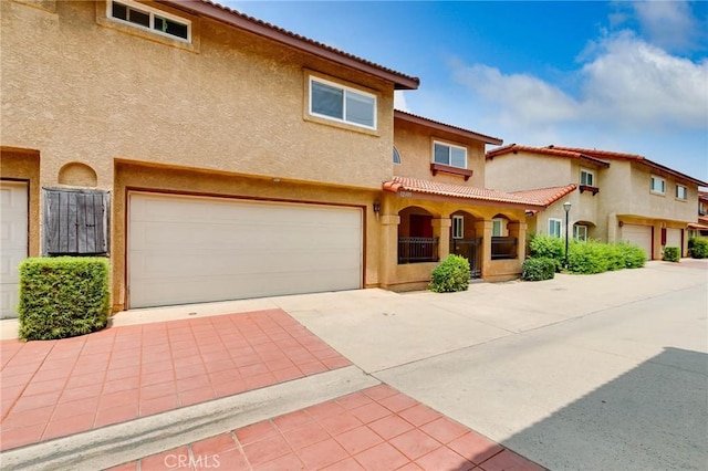 12105 Ramona Blvd, El Monte, CA 91732 - mediterranean / spanish-style house with stucco siding, an attached garage, concrete driveway, and a tile roof
