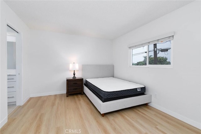 12105 Ramona Blvd, El Monte, CA 91732 - bedroom with light wood-style floors and baseboards