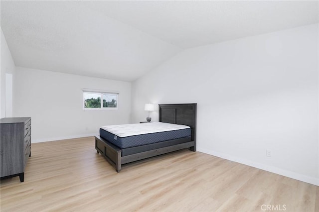 12105 Ramona Blvd, El Monte, CA 91732 - bedroom featuring light wood-style floors, vaulted ceiling, and baseboards