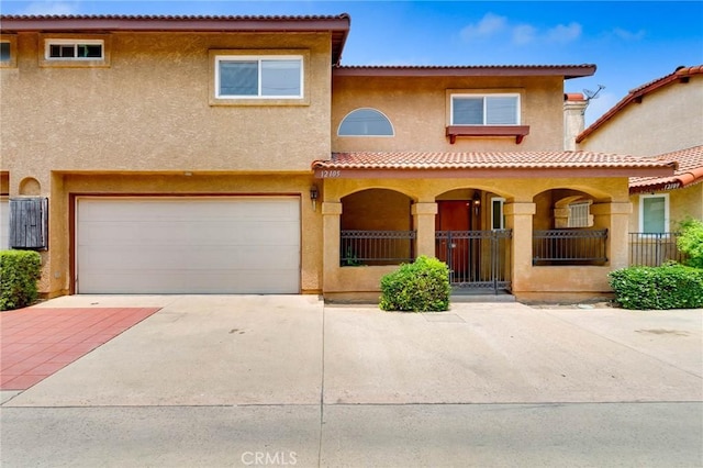 12105 Ramona Blvd, El Monte, CA 91732 - mediterranean / spanish house with stucco siding, concrete driveway, a porch, and a garage