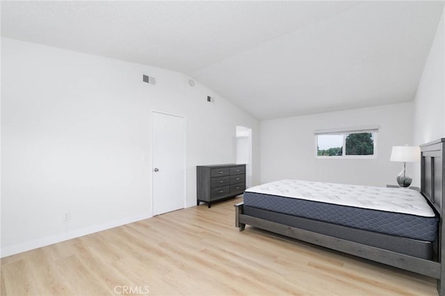 12105 Ramona Blvd, El Monte, CA 91732 - bedroom with vaulted ceiling and light wood-style flooring