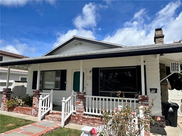 1054 W 23rd St, San Pedro, CA 90731 - view of front of home featuring a porch and a chimney