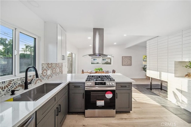 957 N Jasmine Ave, Ontario, CA 91762 - kitchen featuring island exhaust hood, stainless steel appliances, a sink, gray cabinetry, and a peninsula