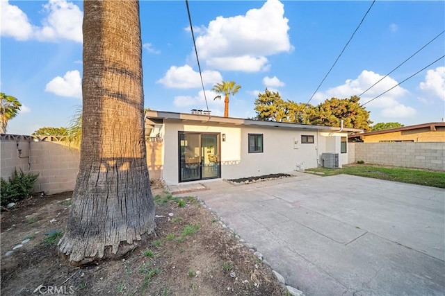 957 N Jasmine Ave, Ontario, CA 91762 - rear view of house with stucco siding, central AC, and a patio area