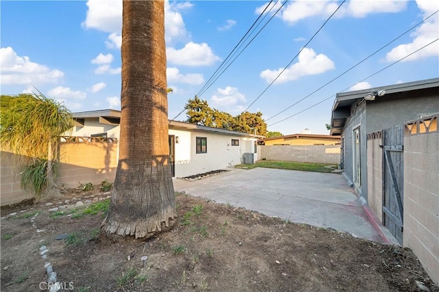 957 N Jasmine Ave, Ontario, CA 91762 - rear view of house with a patio area, a fenced backyard, and central air condition unit