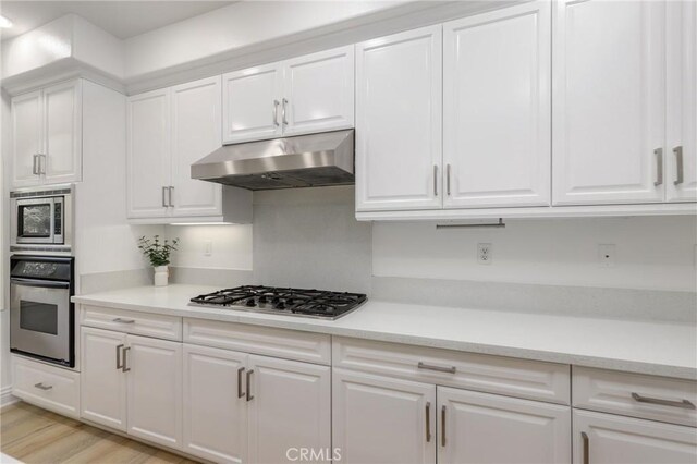 211 Groveland, Irvine, CA 92620 - kitchen featuring stainless steel appliances, under cabinet range hood, white cabinetry, and light countertops
