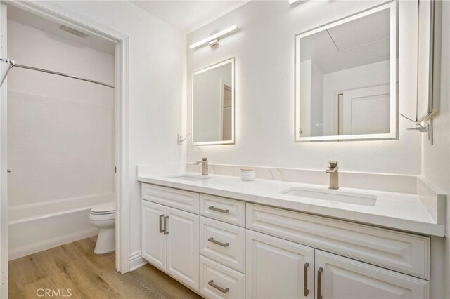 211 Groveland, Irvine, CA 92620 - bathroom featuring double vanity, toilet, wood finished floors, and  shower combination