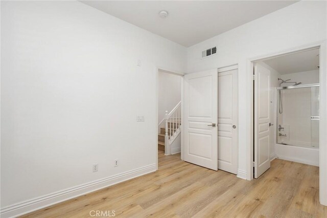 211 Groveland, Irvine, CA 92620 - unfurnished bedroom with light wood-style floors, baseboards, and ensuite bath
