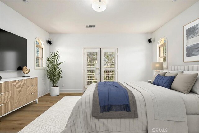 211 Groveland, Irvine, CA 92620 - bedroom featuring wood finished floors, multiple windows, and baseboards