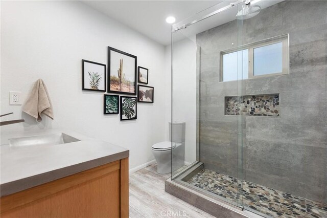 18770 Community St, Northridge, CA 91324 - full bathroom featuring a shower stall, wood finished floors, vanity, and toilet