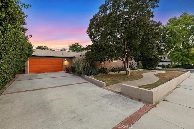 18770 Community St, Northridge, CA 91324 - view of front of property with a garage, driveway, and stucco siding
