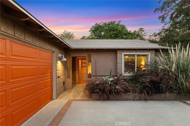 18770 Community St, Northridge, CA 91324 - ranch-style house featuring a garage, a shingled roof, and stucco siding