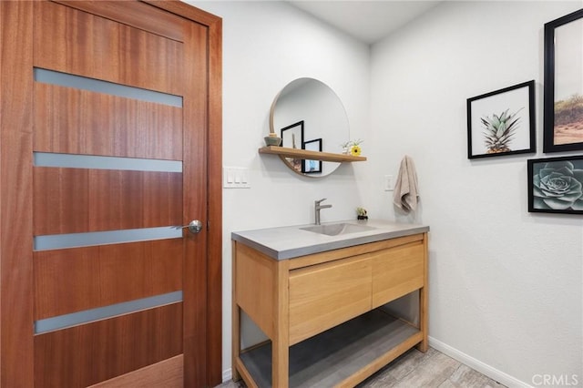 18770 Community St, Northridge, CA 91324 - bathroom with vanity, wood finished floors, and baseboards