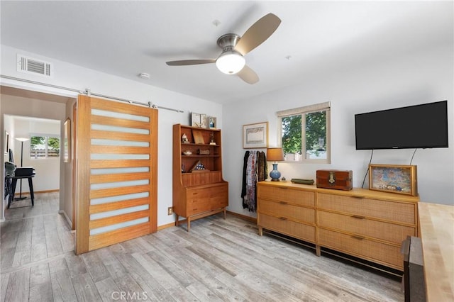 18770 Community St, Northridge, CA 91324 - bedroom featuring light wood-style floors and a barn door