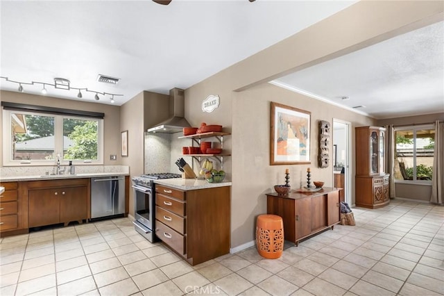 18770 Community St, Northridge, CA 91324 - kitchen featuring stainless steel appliances, wall chimney exhaust hood, a sink, light tile patterned floors, and brown cabinetry