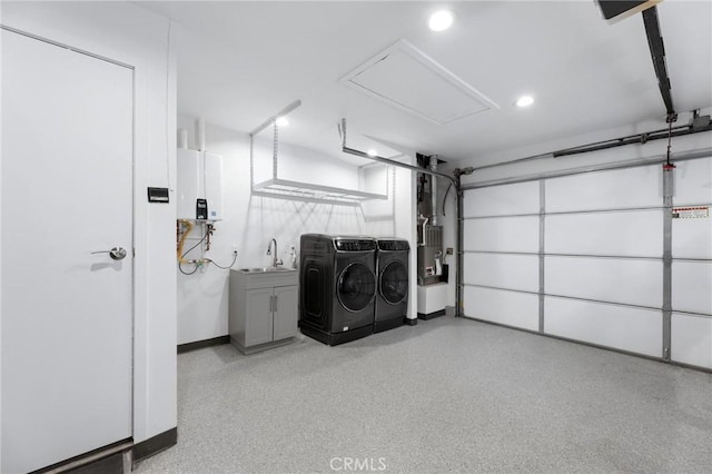 18770 Community St, Northridge, CA 91324 - garage featuring independent washer and dryer, water heater, a sink, recessed lighting, and baseboards