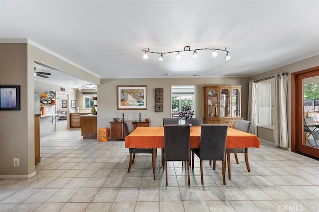 18770 Community St, Northridge, CA 91324 - dining area with plenty of natural light, light tile patterned flooring, crown molding, baseboards, and rail lighting