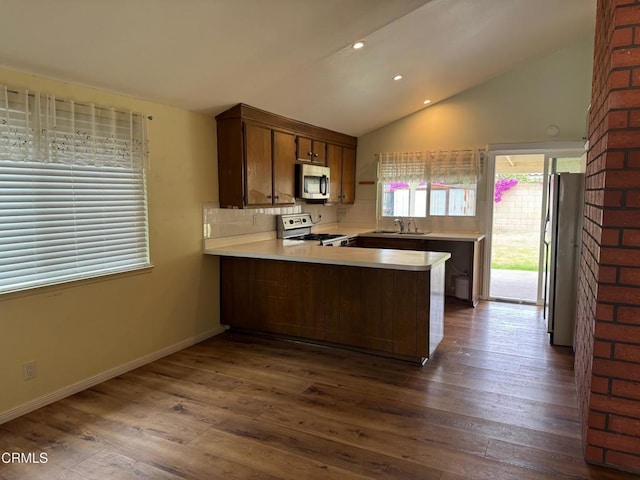 1721 Joliet Pl, Oxnard, CA 93030 - kitchen with stainless steel microwave, range with gas cooktop, freestanding refrigerator, a peninsula, and light countertops